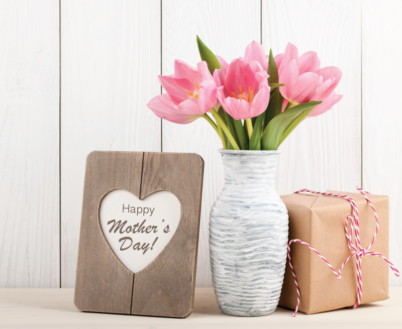 Pink tulip flowers with Mothers Day sign and Mother's Day gift.